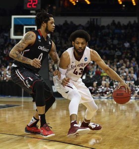 DeAndre Bembry No.43 of the Saint Joseph’s Hawks drives against Quadri Moore No.0 of the Cincinnati Bearcats in the first half during the first round of the 2016 NCAA Men’s Basketball Tournament at Spokane Veterans Memorial Arena on March 18, 2016 in Spokane, Washington. AFP PHOTO 