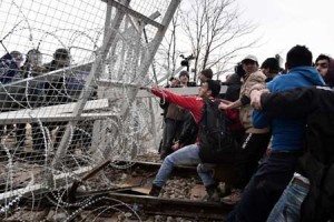 Asylum seekers open the gate at the Greek-Macedonian borders during their protest. AFP PHOTO