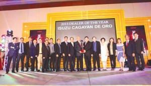 Executives from Isuzu Philippines Corporation pose on stage with officials and staff of Isuzu Cagayan de Oro during the awarding ceremony.