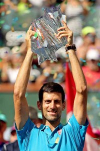 Novak Djokovic of Serbia celebrates with the winner’s trophy after defeating Milos Roanic of Canada during the mens final of the BNP Paribas Open at the Indian Wells Tennis Garden on Monday in Indian Wells, California. AFP PHOTO