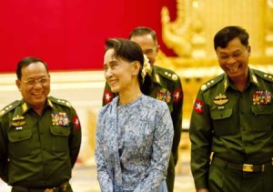 THE LADY AS MINISTER Newly sworn in Myanmar Foreign Minister Aung San Suu Kyi and a military general share a light moment during the handover ceremony at the presidential palace in Naypyidaw, March 30. AFP PHOTO