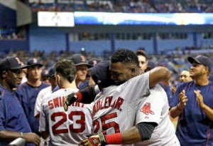 David Ortiz (center right) of the Boston Red Sox hugs teammate Jackie Bradley Jr. as he celebrates after hitting his 500th career MLB home run, during the fifth inning of their game against the Tampa Bay Rays, in St. Petersburg, Florida, on September 12, 2015. AFP FILE PHOTO