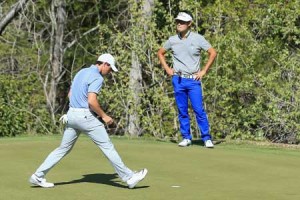 Rory McIlroy of Northern Ireland holes out as Kevin Na of the United States looks on as Mcilroy wins their match on the second playoff hole during the third round of the World Golf Championships-Dell Match Play at the Austin Country Club on Saturday in Austin, Texas. AFP PHOTO