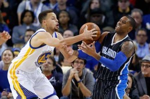 Stephen Curry No.30 of the Golden State Warriors and C.J. Watson No. 32 of the Orlando Magic go for a loose ball at ORACLE Arena on Tuesday in Oakland, California. AFP PHOTO