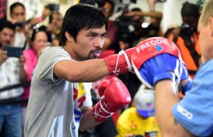 Pacquiao hits the mitts with trainer Freddie Roach. AFP PHOTO