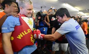 Manny Pacquiao throws a mock punch to coach Freddie Roach during training. AFP FILE PHOTO