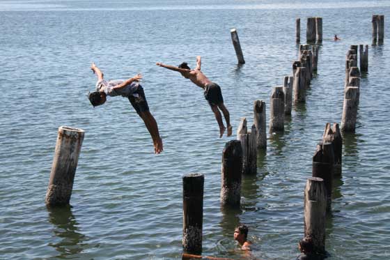 Young boys frolic in Manila Bay as the temperature creeps up, signaling the start of summer. The weather bureau said the country can expect hotter days ahead. PHOTO BY JOEL MINA FERNANDEZ