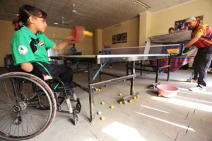 Twelve-year-old disabled Iraqi Nejla Imad plays table tennis in Baquba, a city northeast of Baghdad, on February 20, 2016. AFP PHOTO