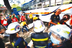 WAYWARD BUS Members of a fire rescue team check for survivors after a commuter bus rammed a UV Express van and an eatery, killing three commuters, including a pregnant woman and her unborn child. Photo by Ruy L. Martinez