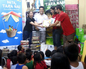 Real estate executive Jhops Cruz, and Books for A Cause founder Ramil Sumangil turn over donated books to French volunteers Katia and Henri Ollivier of Phil Book Library