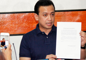 PROOF? Sen. Antonio Trillanes holds a document that he claims is part of bank documents showing the bank deposits of Davao Mayor Rodrigo Duterte. PHOTO BY MIKE DE JUAN