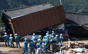 RACE FOR LIFE Rescue workers try to save people from a collapsed house in MimamiAso, Kuammoto prefecture. The powerful quake that hit southern Japan toppled buildings and triggered a massive landslide. JAPAN OUT