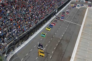 Kyle Busch, driver of the yellow M&M’s 75th Anniversary Toyota, leads a pack of race cars during the NASCAR Sprint Cup Series STP 500 at Martinsville Speedway on Monday in Martinsville, Virginia. AFP PHOTO