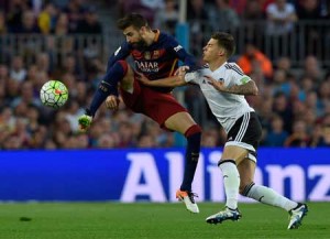 Barcelona’s defender Gerard Pique (left) vies with Valencia’s forward Santi Mina during the Spanish league football match FC Barcelona vs Valencia CF at the Camp Nou stadium in Barcelona on Monday. AFP PHOTO