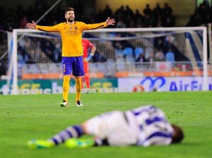 Barcelona’s defender Gerard Pique gestures during the Spanish league football match Real Sociedad vs FC Barcelona at the Anoeta stadium in San Sebastian on April 9.    AFP PHOTO 