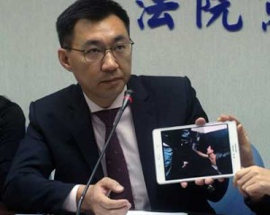 Johnny Chiang, a legislator from the Kuomintang (KMT) party, displays a video clip showing Taiwanese nationals detained at a police station in Kenya, during a news conference in Taipei, on April 12. AFP PHOTO