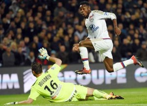 Lyon’s French forward Maxwell Cornet (left) runs to score a goal next past Montpellier’s French goalkeeper Geoffrey Jourdren on Saturday at the Mosson stadium in Montpellier, southern France, during the French Ligue1 football match Montpellier vs Lyon. AFP PHOTO