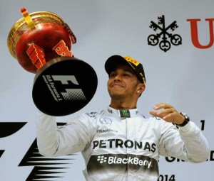 This file photo taken on April 20, 2014 shows Mercedes AMG Petronas driver Lewis Hamilton of Britain lifting the trophy after winning the Formula One Chinese Grand Prix in Shanghai. AFP PHOTO