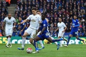 Leicester City’s Ghanaian striker Jeff Schlupp (right) plays the ball as Swansea City’s Argentinian defender Federico Fernandez (left) defends during the English Premier League football match between Leicester City and Swansea at King Power Stadium in Leicester, central England on Monday. AFP PHOTO