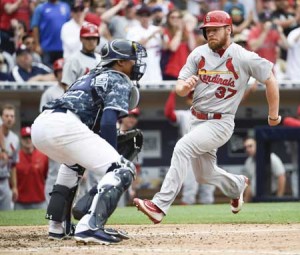 Brandon Moss No.37 of the St. Louis Cardinals scores ahead of the throw to Christian Bethancourt No.12 of the San Diego Padres during the eighth inning of a baseball game at PETCO Park on Monday in San Diego, California. AFP PHOTO