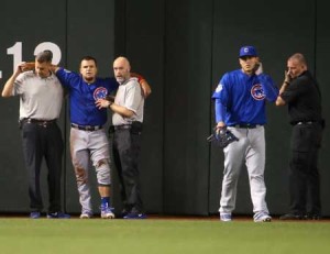 Outfielder Kyle Schwarber No.12 of the Chicago Cubs is helped up by team trainers after an injury during the second inning of the MLB game against the Arizona Diamondbacks at Chase Field on April 7 in Phoenix, Arizona. AFP PH