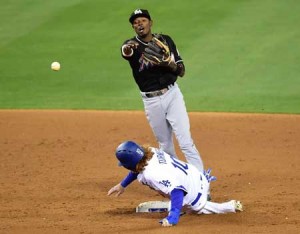 Dee Gordon No.9 of the Miami Marlins turns a double play over Justin Turner No.10 of the Los Angeles Dodgers to end the sixth inning at Dodger Stadium on April 25, 2016 in Los Angeles, California. AFP PHOTO