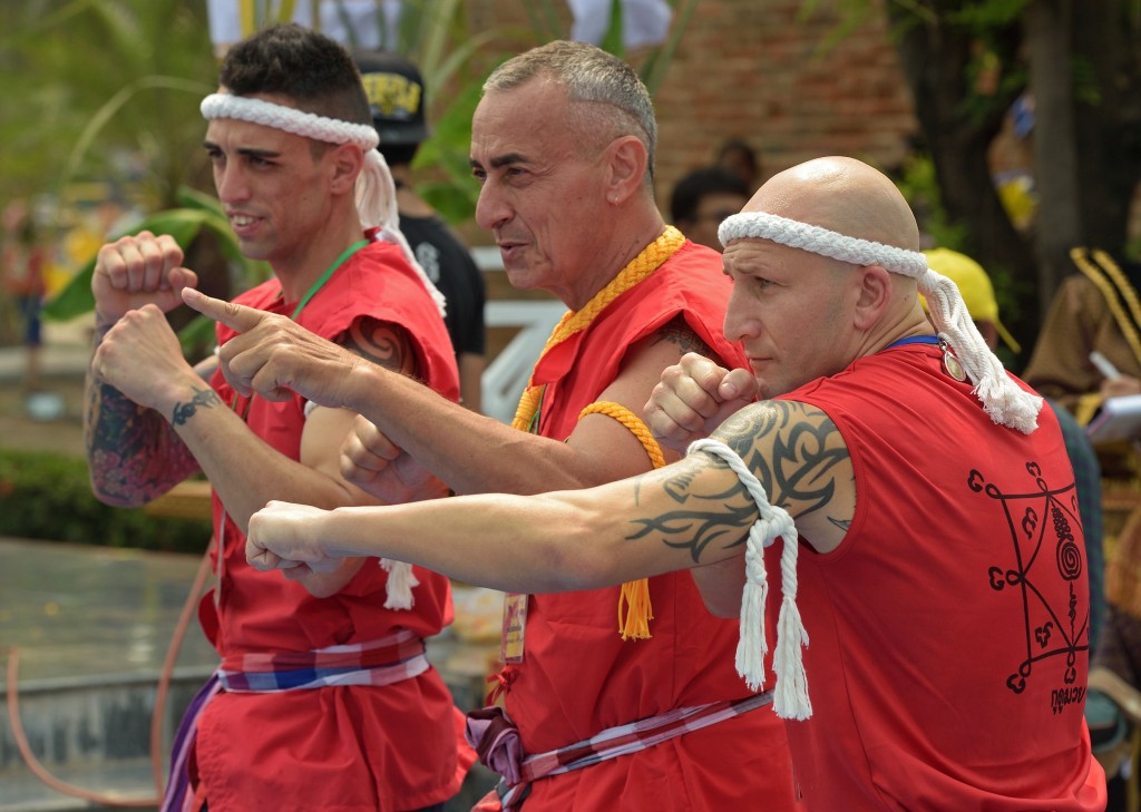 Foreign boxers pose during the 11th Wai Kru Muay Thai ceremony in Ayutthaya province on March 17, 2015. The 11th Wai Kru Muay Thai ceremony is being held to showcase some of the sacred rituals of Thai boxing, a martial art that has kicked itself into the worlds spotlight over the years and gained fans the world over. AFP PHOTO / PORNCHAI KITTIWONGSAKUL