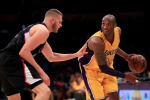 Kobe Bryant No.24 of the Los Angeles Lakers handles the ball against Cole Aldrich No.45 of the Los Angeles Clippers during the second half of an NBA game between the Los Angeles Clippers and  Los Angeles Lakers on Thursday at Staples Center in Los Angeles, California.  AFP PHOTO