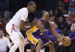 Kobe Bryant No. 24 of the Los Angeles Lakers tries to drive around Kevin Durant No.35 of the Oklahoma City Thunder during the first quarter of a NBA game at the Chesapeake Energy Arena in Oklahoma City, Oklahoma. AFP PHOTO