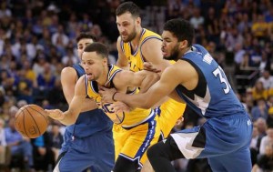 Stephen Curry No.30 of the Golden State Warriors tries to dribble between Ricky Rubio No.9 and Karl-Anthony Towns No.32 of the Minnesota Timberwolves at ORACLE Arena on Wednesday in Oakland, California. AFP PHOTO