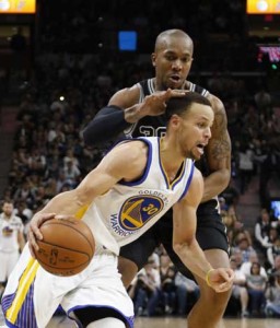 Stephen Curry No.30 of the Golden State Warriors drives in front of David West No.30 of the San Antonio Spurs at AT&T Center on Monday in San Antonio, Texas. AFP PHOTO