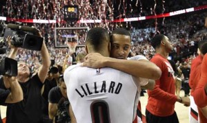 Damian Lillard No.0 and C.J. McCollum No.3 of the Portland Trail Blazers celebrate after winning Game Six of the Western Conference quarterfinals against the Los Angeles Clippers during the 2016 NBA Playoffs at the Moda Center on Saturday in Portland, Oregon. The Blazers won 106-103. AFP PHOTO