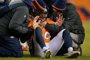 Strong safety David Bruton No.30 of the Denver Broncos is attended to by trainers after a play that would force him out of the game with a reported concussion during a game against the Oakland Raiders on December 28, 2014 in Denver, Colorado.  AFP FILE PHOTO