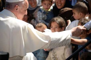 TOUCHING LIVES Pope Francis greets migrants and refugees at the Moria refugee camp on Saturday near the port of Mytilene, on the Greek island of Lesbos. AFP PHOTO