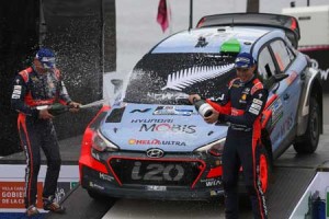 New Zealander driver Hayden Paddon (right) and his compatriot co-driver John Kennard (left) spray champagne on each other while they celebrate their win on the final podium of the World Rally Championship Argentina 2016 near Villa Carlos Paz, Cordoba, Argentina on Monday. AFP PHOTO