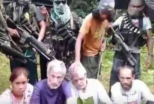 WAITING FOR RESCUERS This photo, taken by BBC before the execution, shows Canadian John Ridsdel and the other hostages of the Abu Sayyaf Group.