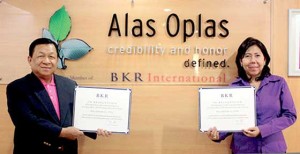 Chairman/CEO Donnies T. Alas and Managing Partner Marycris S. Oplas of Alas Oplas & Co., CPAs receive a certificate of membership from BKR International, one of the top professional services organizations in the world.