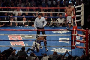 Pacquiao walks to his corner after knocking down Bradley