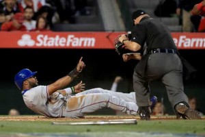 Elvis Andrus (No. 1) of the Texas Rangers reacts to being called out by umpire Mark Carlson on a play at the plate during 4th inning of a baseball game between the Los Angeles Angels of Anaheim and Texas Rangers at Angel Stadium of Anaheim in Anaheim, California. AFP PHOTO