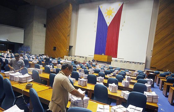 Workers arrange documents at the session hall as the House of Representatives prepares to canvass votes for the presidential and vice presidential candidates. PHOTO BY MIKE DE JUAN