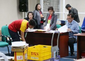 OVERSEAS VOTES Workers check ballot boxes containing the votes of Filipinos in 26 countries. The certificates of canvass for the presidential and vice presidential candidates will be officially counted by Congress when it convenes as the National Board of canvassers on May 25. PHOTO BY RENE DILAN 