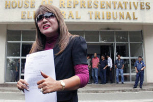 CHEATED? Imelda Papin holds a copy of the electoral complaint she filed against her rival, Camarines Sur 4th District Rep. Arnulfo Fuentebella. PHOTO BY MIKE DE JUAN 