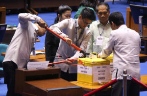 COUNT GOES ON Lawmakers inspect a ballot box on the second day of the official canvassing of votes for President and Vice President. As of 7 p.m. Thursday, Sen. Ferdinand “Bongbong” Marcos Jr. was leading by 255, 254 votes.  PHOTO BY RUY L. MARTINEZ 