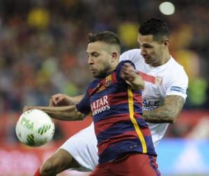 Sevilla’s midfielder Vitolo (right) clashes with Barcelona’s defender Jordi Alba as he scores a goal scoring during the Spanish “Copa del Rey” (King’s Cup) final match FC Barcelona vs Sevilla FC at the Vicente Calderon stadium in Madrid on Monday. AFP PHOTO