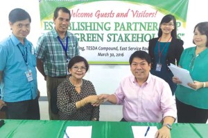 EVAP president Rommel Juan (seated, right) shakes the hand of TESDA Director Felicidad Zurbano after signing the memorandum of agreement.