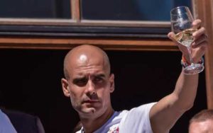 Bayern Munich’s Spanish head coach Pep Guardiola and Bayern Munich’s team members celebrate with their fans winning the trophies of the German Cup and the German League during a FC Bayern Munich team celebration at the Marienplatz square in Munich, southern Germany, on Monday. AFP PHOTO