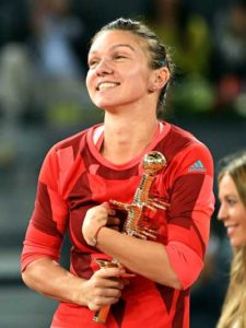 Romania’s Simona Halep smiles as she holds her trophy after beating Slovakia’s Dominika Cibulkova during the Madrid Open women’s tennis final at the Caja Magica (Magic Box) sports complex in Madrid on May 7. AFP PHOTO