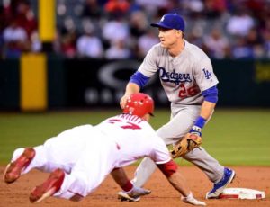 Mike Trout No.27 of the Los Angeles Angels steals second base as Chase Utley No.26 of the Los Angeles Dodgers waits for the throw during the first inning at Angel Stadium of Anaheim on Friday in Anaheim, California.   AFP PHOTO 