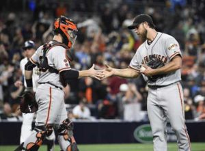 Madison Bumgarner No.40 of the San Francisco Giants, right, is congratulated by Buster Posey No.28 after getting the final out during the ninth inning of a baseball game against the San Diego Padres at PETCO Park on Wednesday in San Diego, California. AFP PHOTO