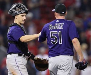 Jake McGee No.51 of the Colorado Rockies and Dustin Garneau No.13 celebrate after defeating the Boston Red Sox 8-2 at Fenway Park on Friday in Boston, Massachusetts.  AFP PHOTO